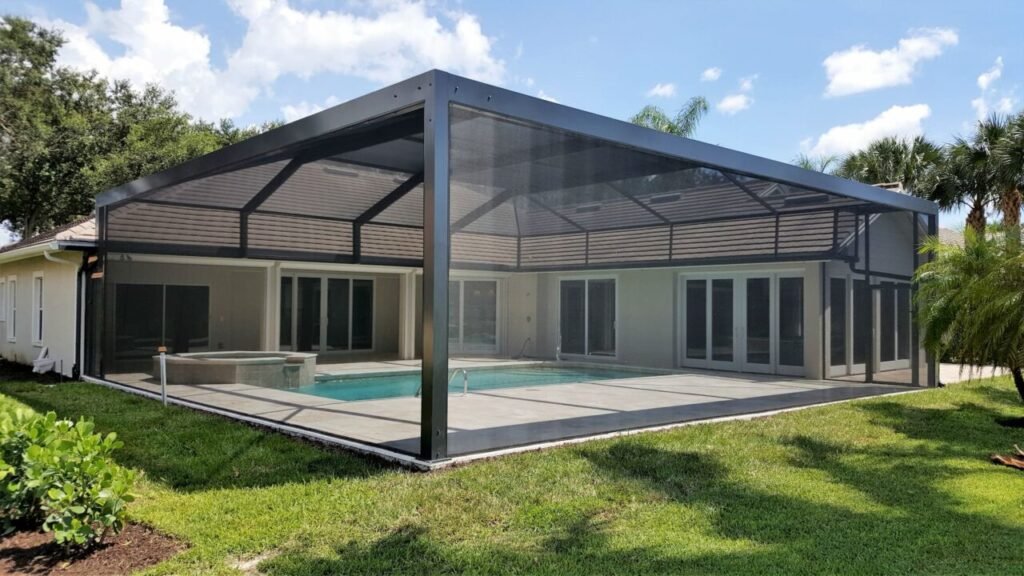 Custom pool enclosure installation in Titusville, FL covering modern residential backyard pool