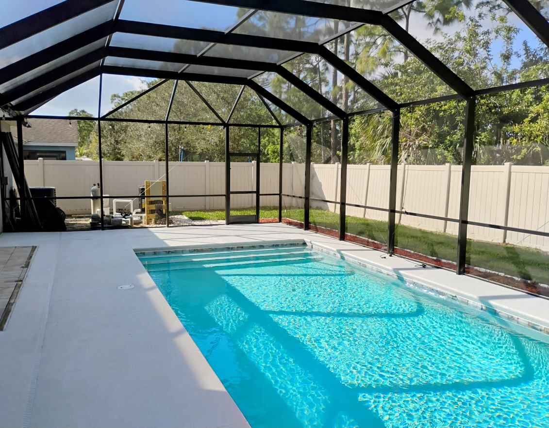 Pool screen enclosure installation in Titusville, FL over residential backyard swimming pool